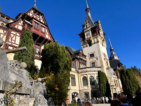       Historical building with ornate facades and towers under a vivid blue sky.
  