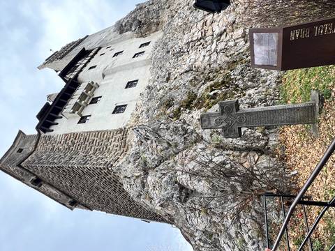 Castle with rough stone walls and steep roofs.