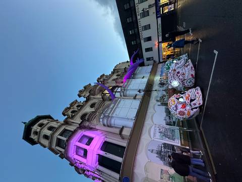 Decorative skulls and building with pink lights at night