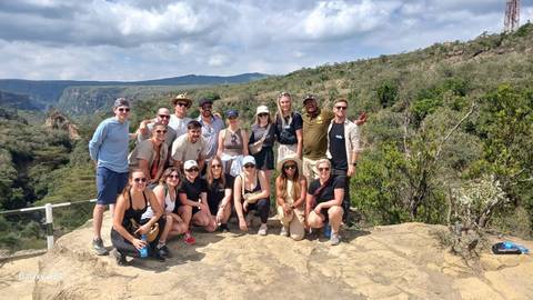       Group of people on a viewpoint overlooking a canyon
  