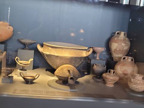       Exhibit of ancient pottery in a glass display.
  