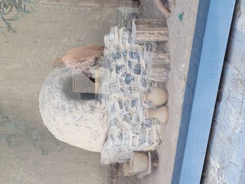 Exhibit with stone oven and clay pots.