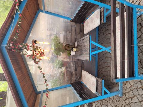       Quaint outdoor sitting area with a wooden table and decorative lights.
  