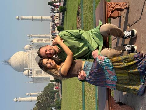 Couple sitting in front of the Taj Mahal.