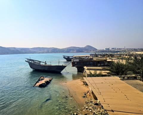 Old wooden boats docked at the shore.