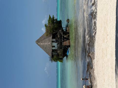 Rustic restaurant built on a rock over the sea.