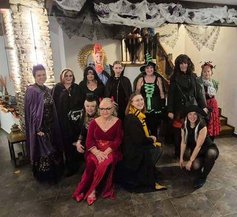 Group of people in Halloween costumes.