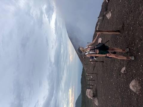 Person standing on a volcanic landscape.