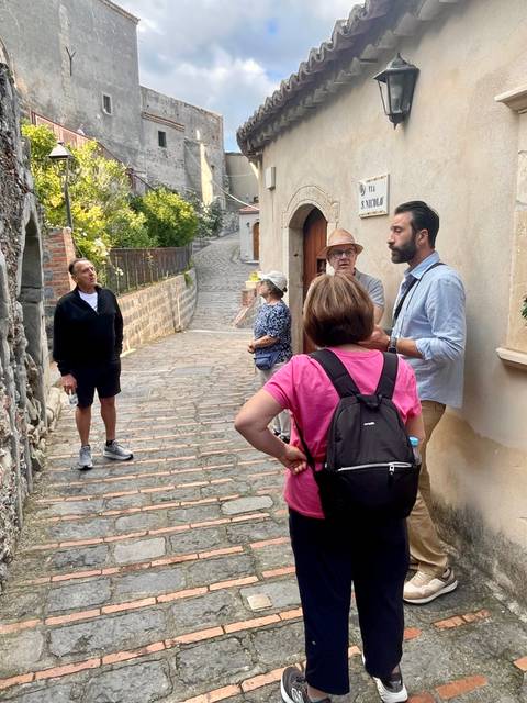      Group of people walking along a stone path
  