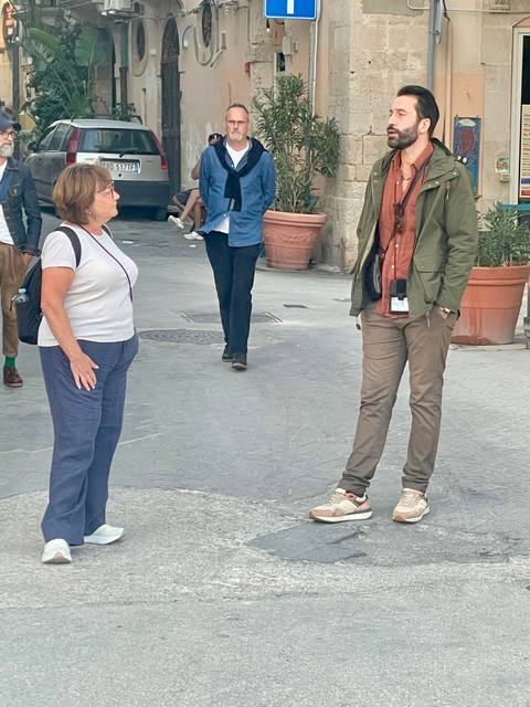       People having a conversation in a street setting
  