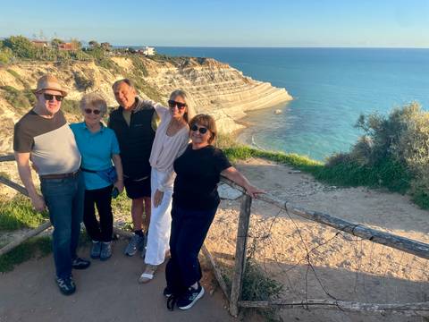       Group posing with a scenic coastal view
  