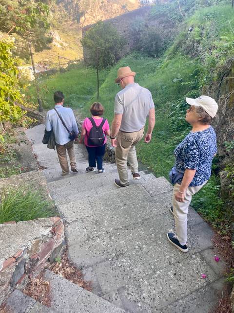       People walking down a stone staircase
  