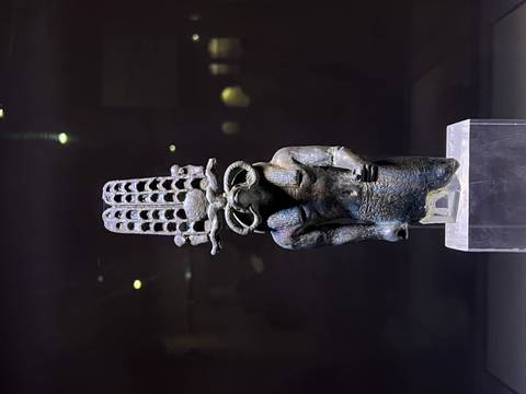 An ancient Egyptian statue displayed in a museum.