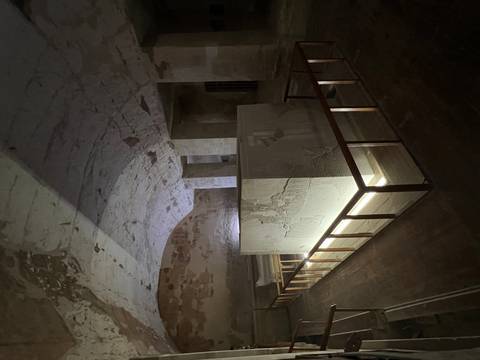 Interior of an ancient Egyptian tomb with carved reliefs.