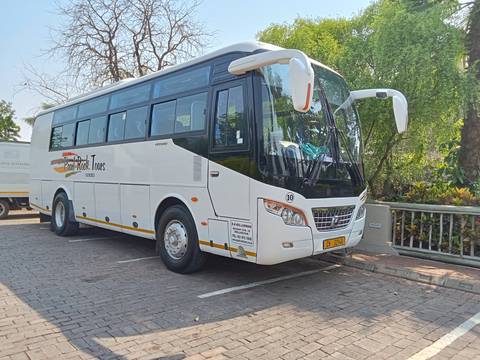       A parked tour bus in an outdoor area.
  