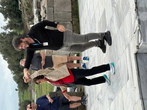 Two people enjoying a dance in an outdoor historical site.