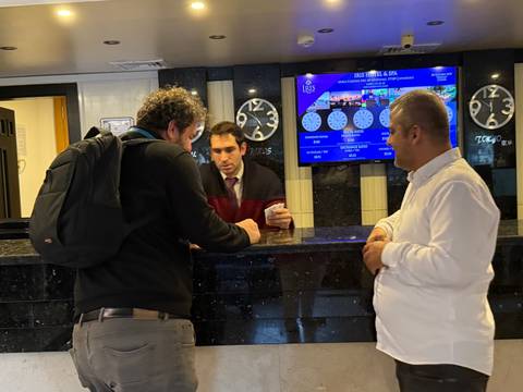 People checking in at a hotel reception.