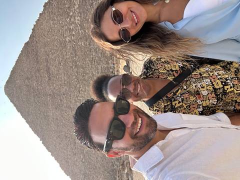 Group selfie with a pyramid in the background.