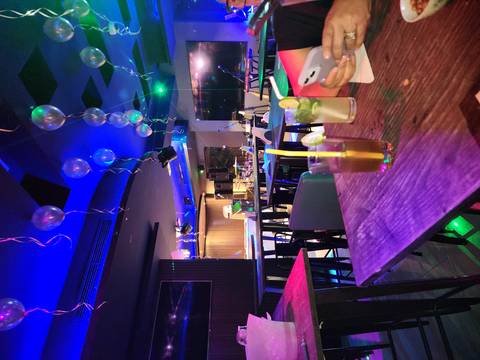       Empty lounge with vibrant lighting and drinks
  