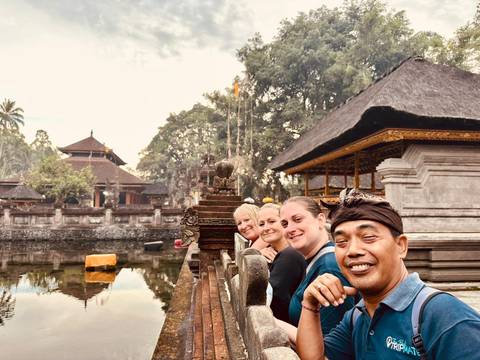 Group at a temple site with traditional architecture.
