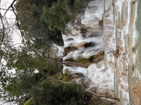       Beautiful cascading waterfall surrounded by lush greenery.
  