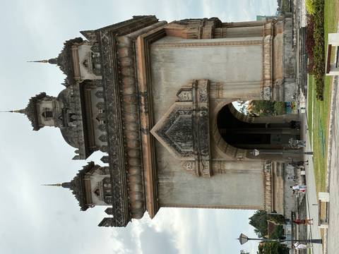       Large monument with intricate details, surrounded by people.
  