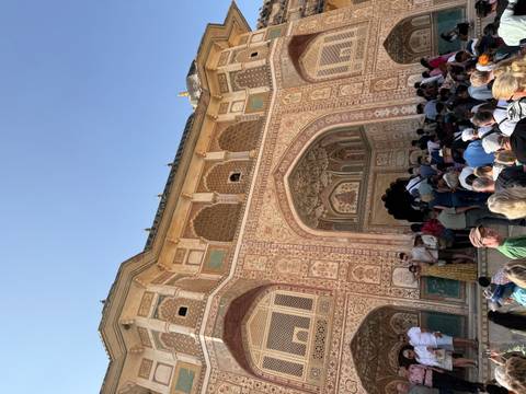 Decorated entryway of a historic building with a crowd.