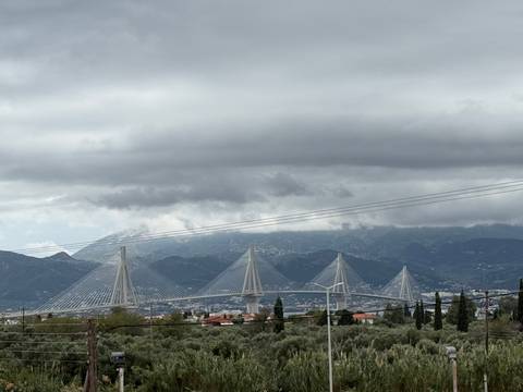       Cabled bridge over a vast landscape.
  