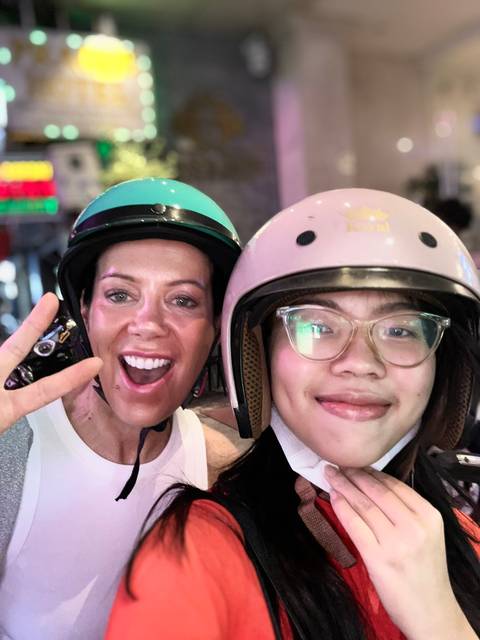 Selfie of two people wearing helmets and smiling.