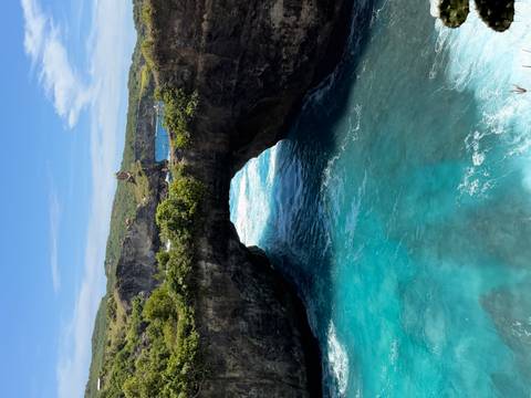       Scenic coastal arch with turquoise waters.
  
