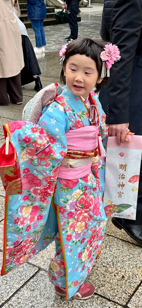 Person dressed in traditional Japanese clothing holding a map.