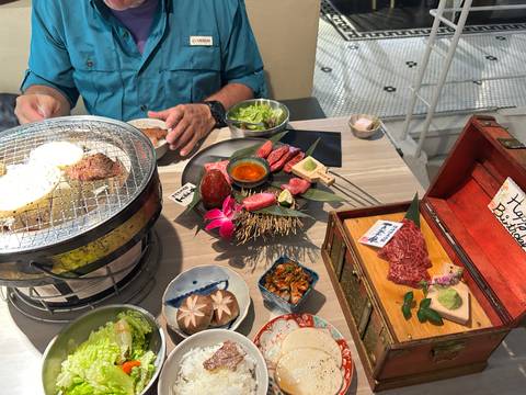 A meal setup with various dishes and a grill on the table.
