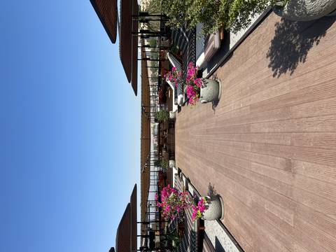 Rooftop lounge area with sunbeds and parasols.