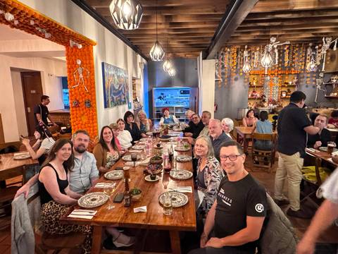 A group of people seated at a restaurant that is decorated for an event.