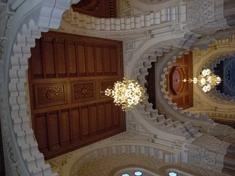 Ceiling with chandeliers and intricate designs.