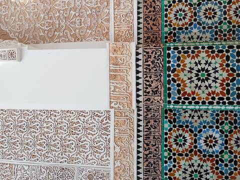       Intricate tile and stucco work on a wall.
  