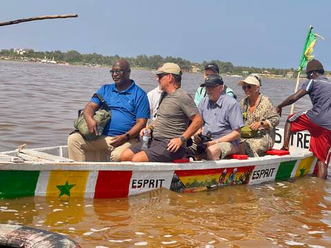 People in a colorful boat on a body of water.