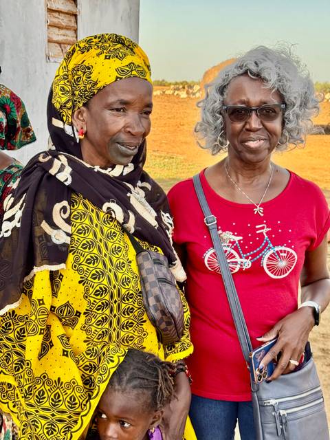 Two women standing together in traditional attire.