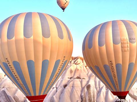       Hot air balloons with Cappadocia landscape in the background.
  