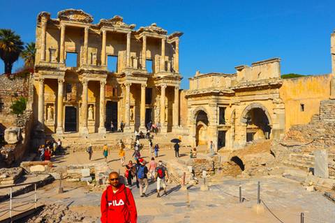People walking near ancient structures.