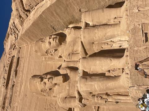 Two large statues of pharaohs carved into rock.