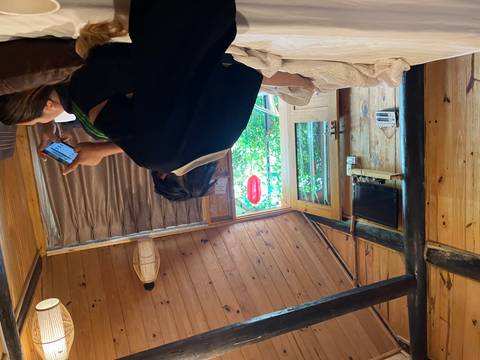       Two people relaxing in a wooden cabin room.
  