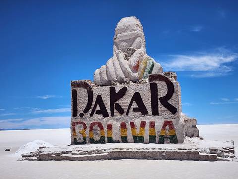       A salt sculpture with the text 'DAKAR BOLIVIA' on the Uyuni Salt Flats.
  