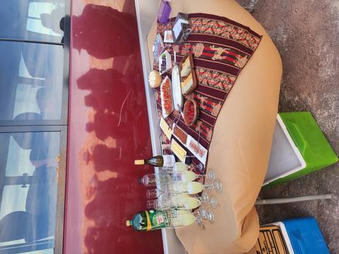       Outdoor setup with food and drinks on a table.
  