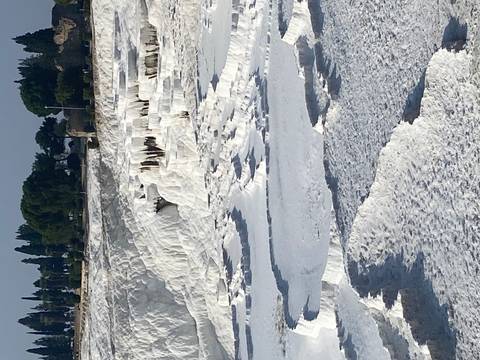       White terraces with mineral deposits in a natural site.
  