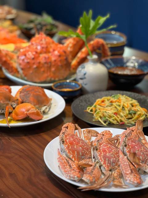       Plates of seafood dishes with colorful presentation.
  