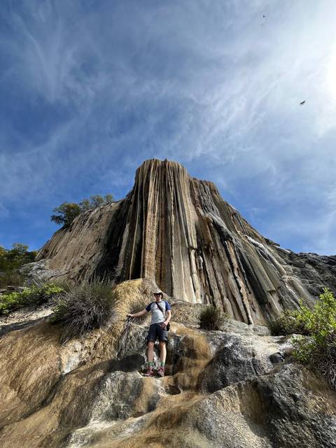 Rock formation with a person sitting in front.