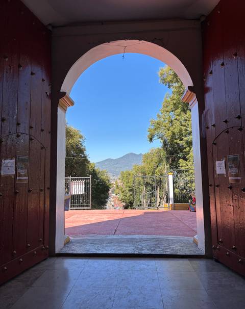 View of a mountain through an open door.