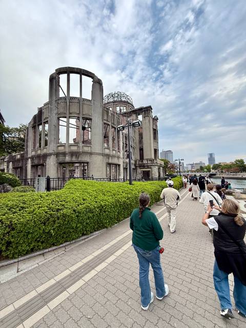 Atomic Bomb Dome in Hiroshima with tourists.