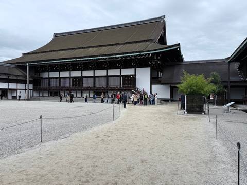       Group of tourists outside a historic building in Kyoto.
  